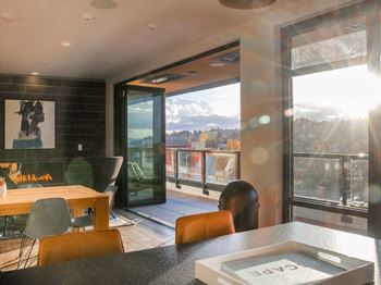 A modern dining room with a view of the mountains outside.